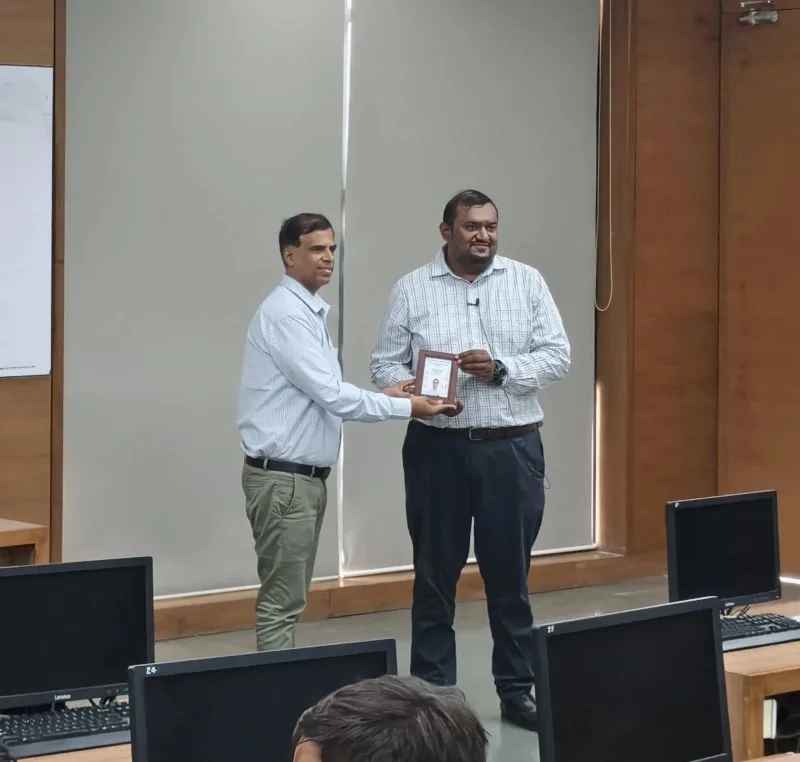 Speaker being presented with a memento